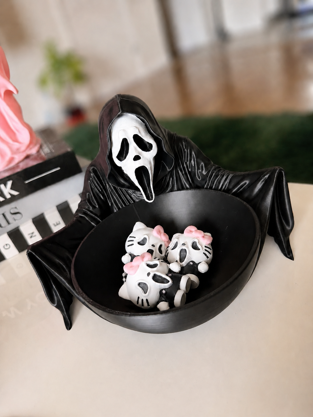 GhostFace decorative bowl holding kitty keychains with softly blurred background