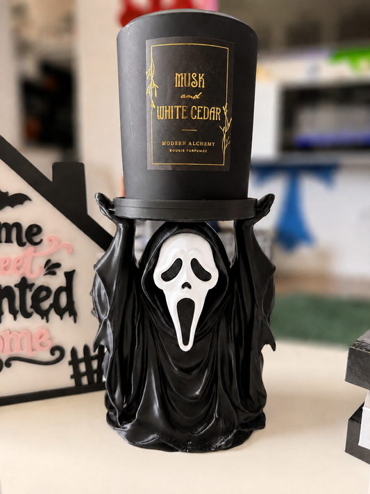 Black GhostFace 2-wick candle holder with bright white mask and softly blurred background