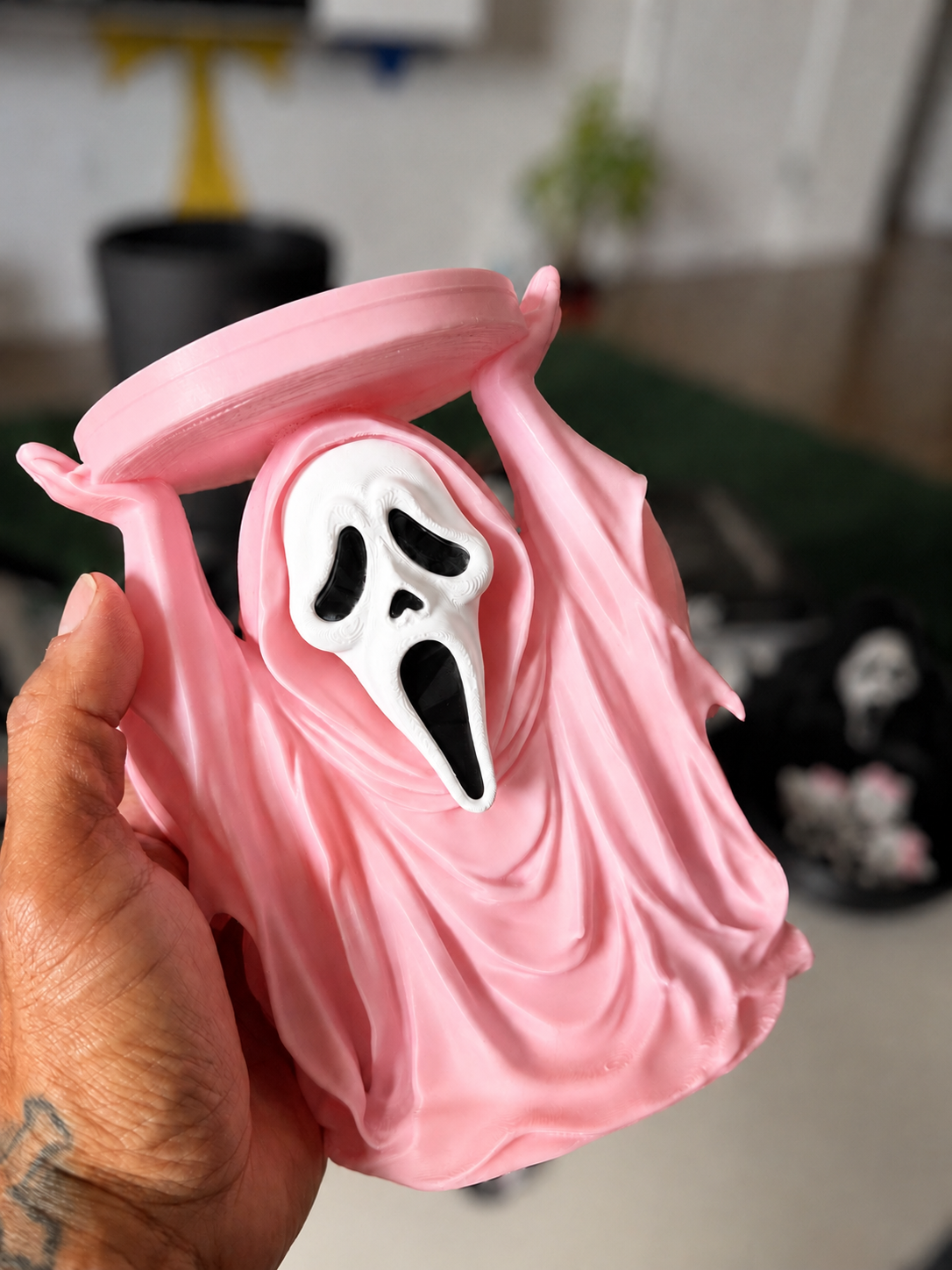 Pink GhostFace candle holder detail with softly blurred background