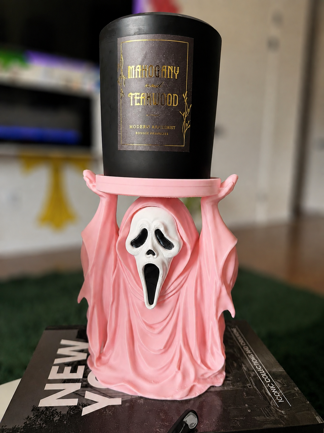Pink GhostFace 2-wick candle holder with bright white mask and softly blurred background