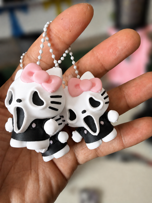GhostFace kitty keychains with bright white finish and softly blurred background