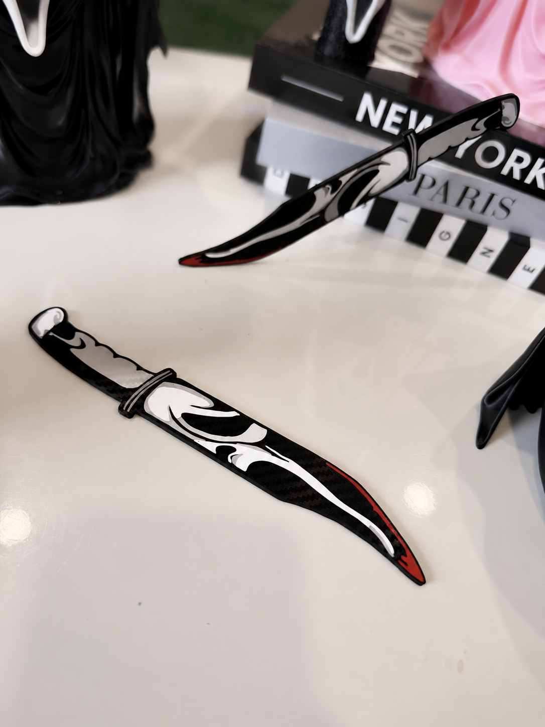 GhostFace decorative prop knives display with softly blurred background