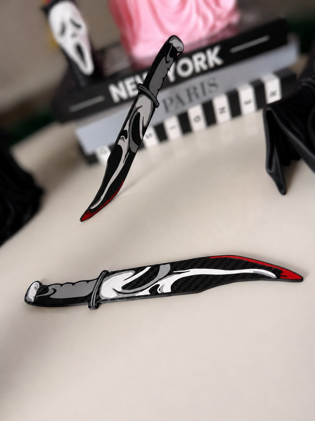GhostFace decorative prop knives pair with cleaner whites and softly blurred background