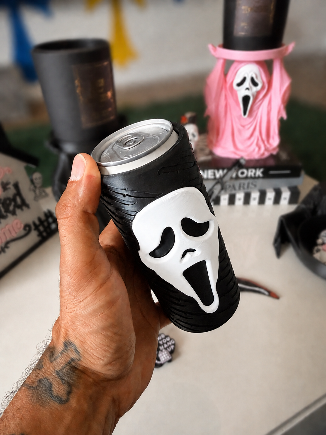 GhostFace 12 oz slim can koozie held in hand with softly blurred background