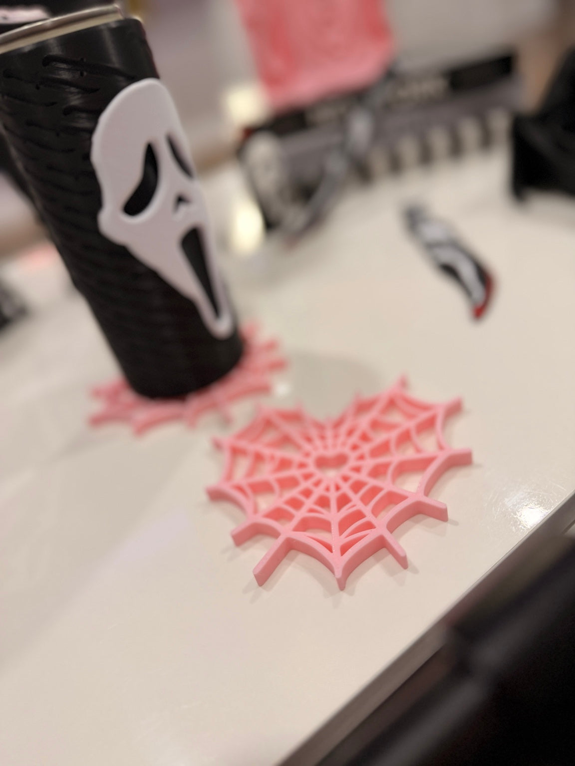 Pink heart spiderweb coaster displayed under a slim can holder